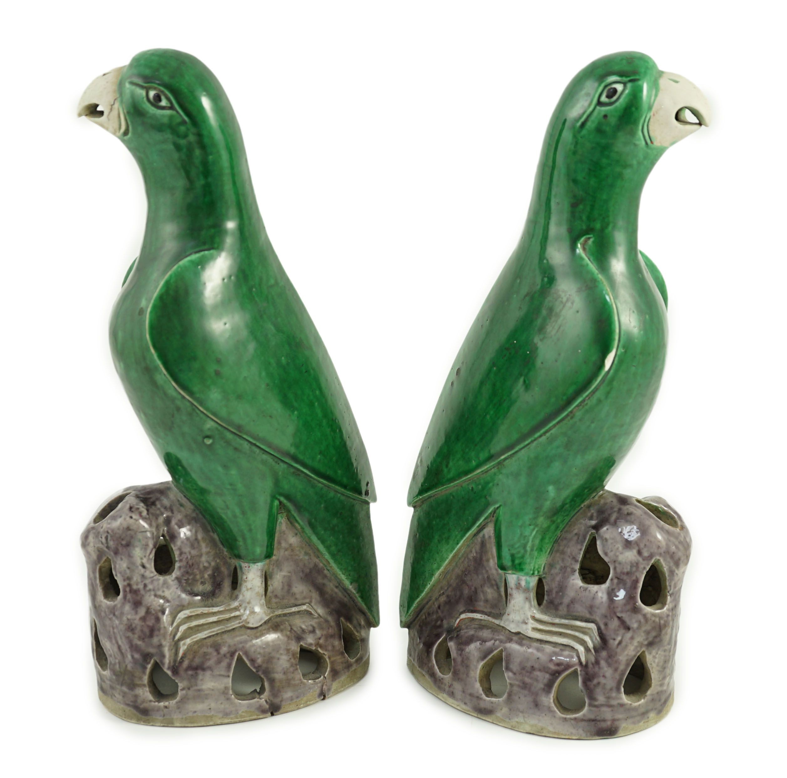 A pair of Chinese green and aubergine glazed models of parrots, 19th century, 27.5cm high